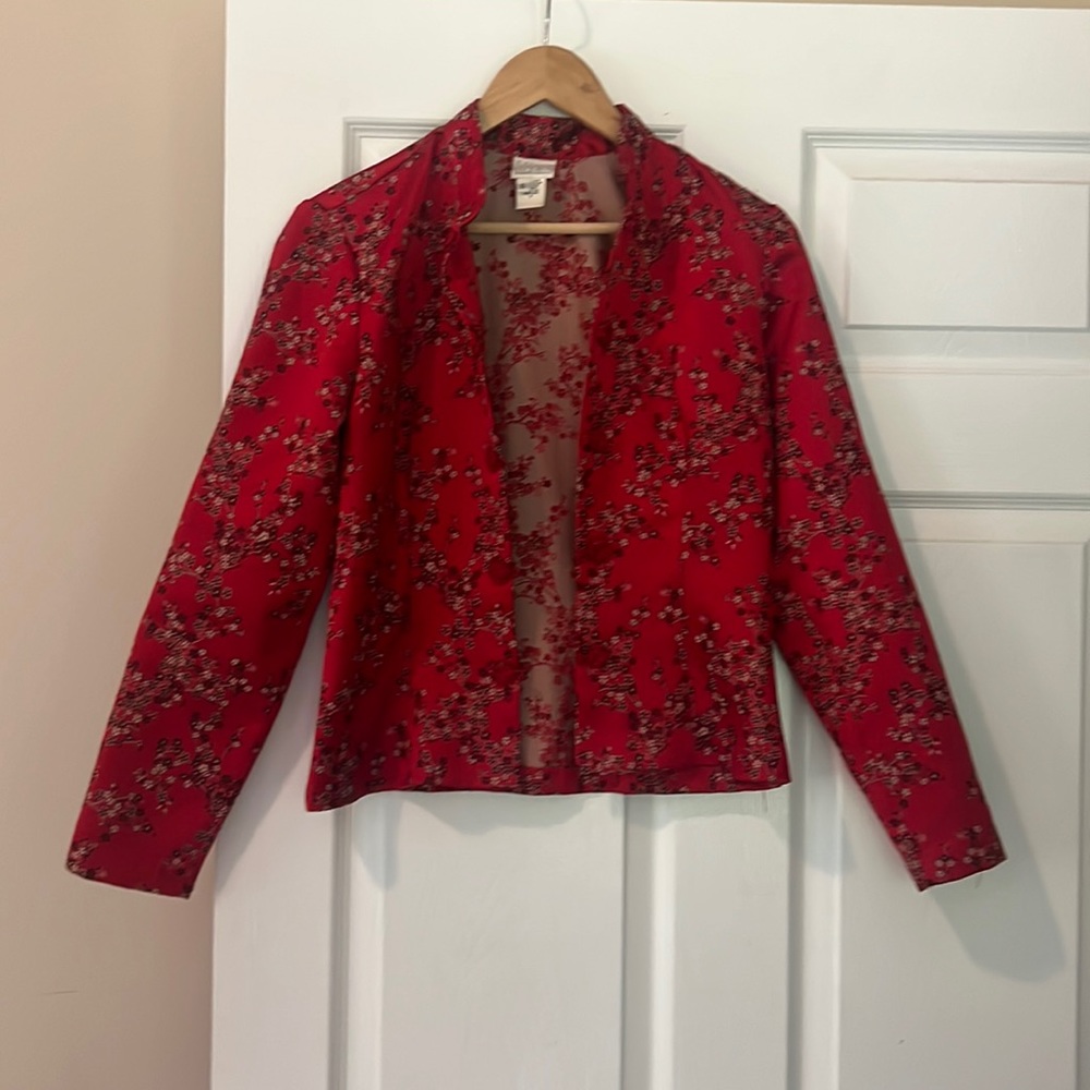 Red satin patterned jacket with frog closures.